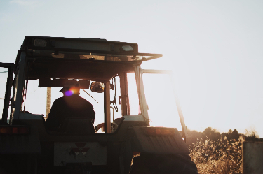 farmer in a tractor in a fielddddd